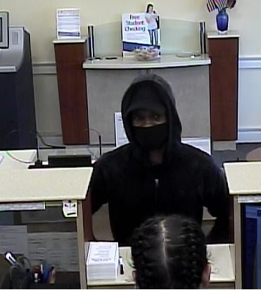 The suspect in a robbery standing at teller counter